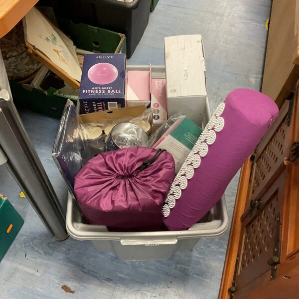 A box containing a variety of fitness equipment for home workouts.
