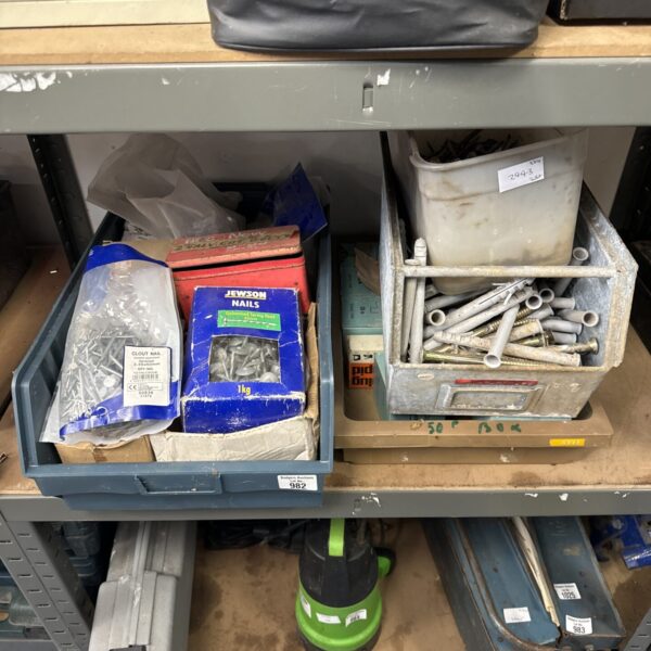 Assorted bolts, nails, and screws in a mixed hardware lot.