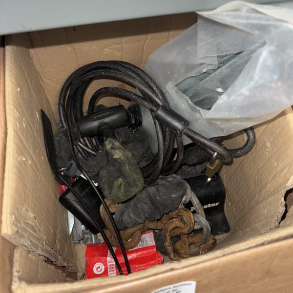 Assorted bicycle security chains and locks in a mixed lot.
