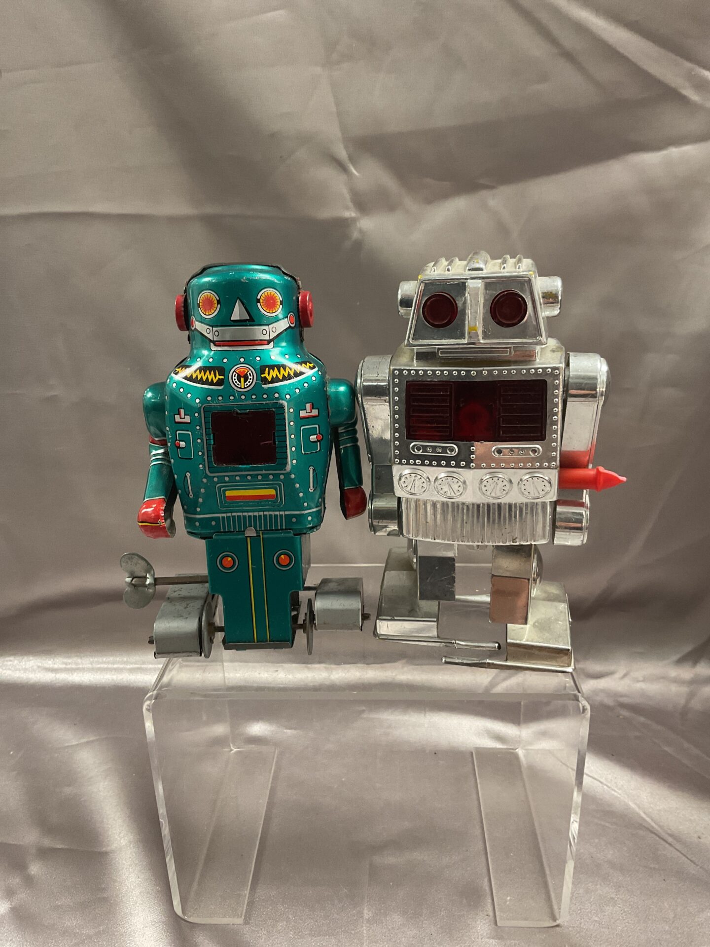 870 Two Vintage Clockwork Robots tinplate green robot made in Japan and silver plastic Hong Kong robot.