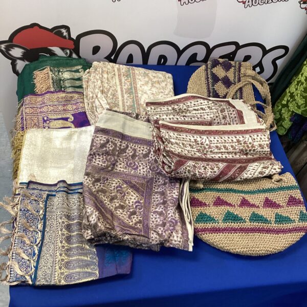 Colourful mixed throws and scarves in a textile lot.