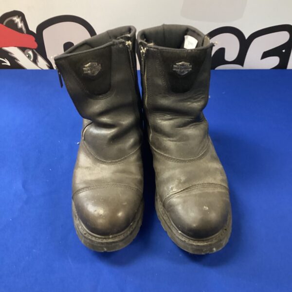 Pair of worn Harley Davidson motorcycle boots, side view.