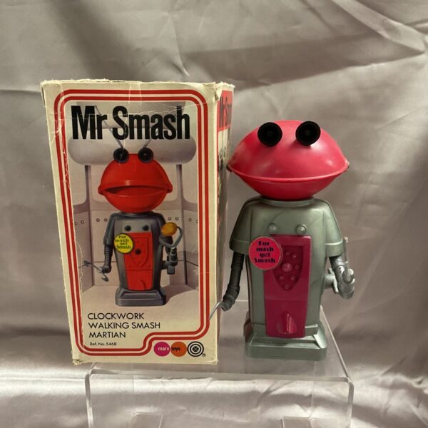 Vintage Marx clockwork Martian tin toy, vibrant red and silver.
