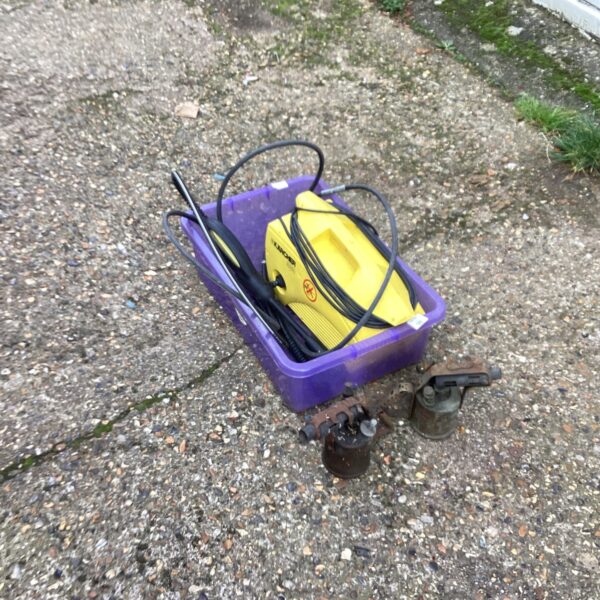 Karcher power washer and vintage brass blow lamps in a plastic crate.