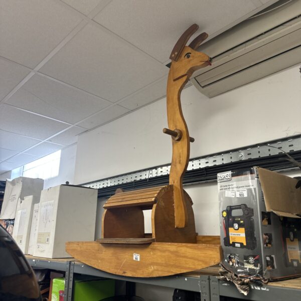Wooden garden rocking llama, whimsical outdoor decoration.