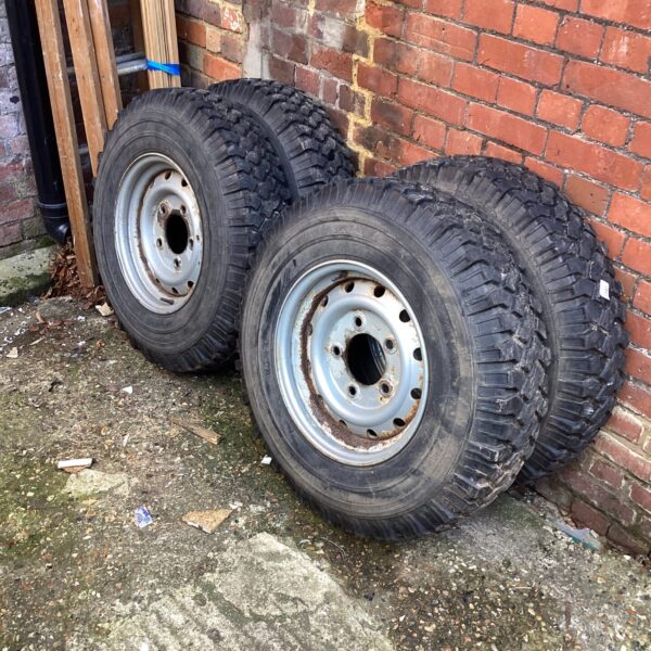 Set of four Land Rover wheels and off-road tyres.