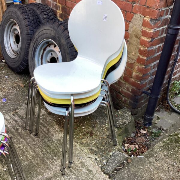 Lot of six vintage retro stacking chairs with yellow seats.