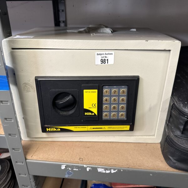 Front view of a used Hilka valuables safe with a key lock.