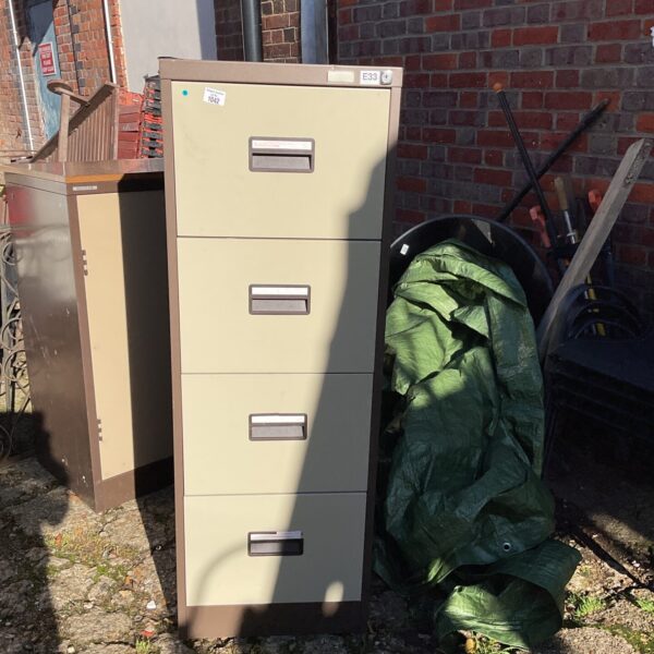Vintage metal filing cabinet with four drawers, ideal for office storage.