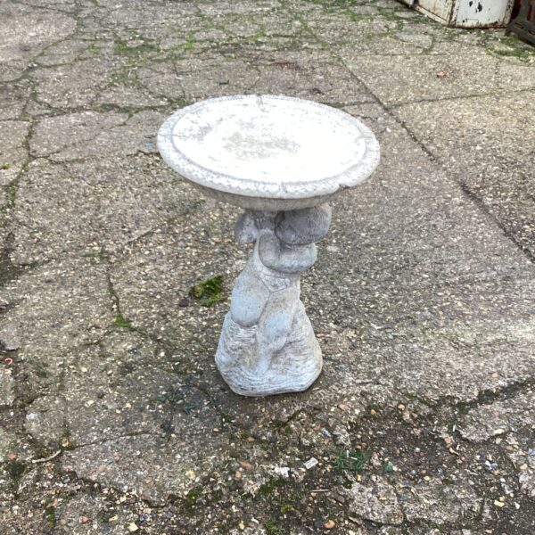 Stone effect garden planter stand for outdoor display.