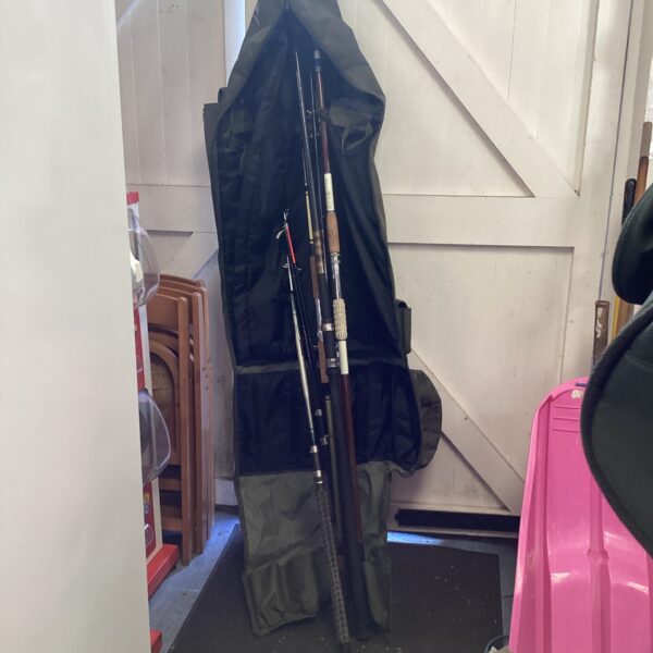 Bundle of sea fishing rods in a black rod bag.
