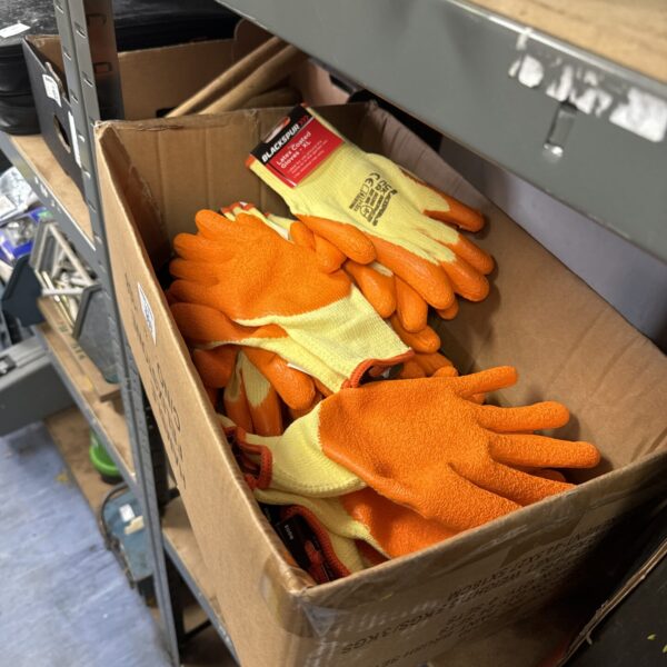 Box of new XL work gloves for construction and DIY.