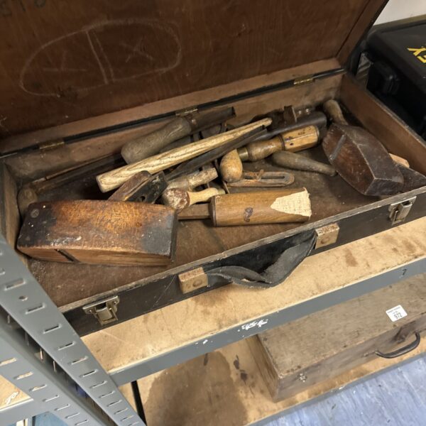 Vintage carpenter's toolbox filled with antique tools for woodworking.