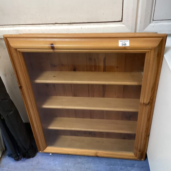 Vintage pine display cabinet with glass front for collectibles.