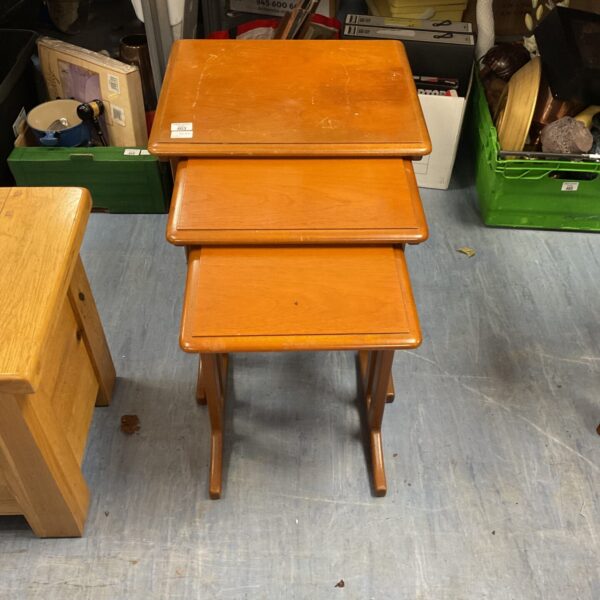 Vintage mid-century teak nest tables with splayed legs.