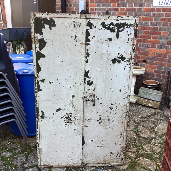 Vintage metal storage cabinet for garage or workshop storage.