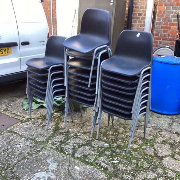 Lot of 23 black stacking chairs for sale.