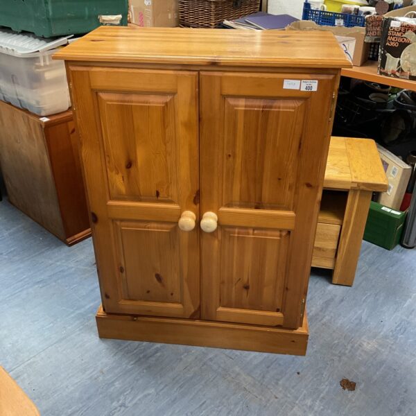 Vintage pine kitchen cabinet with two doors, farmhouse style.