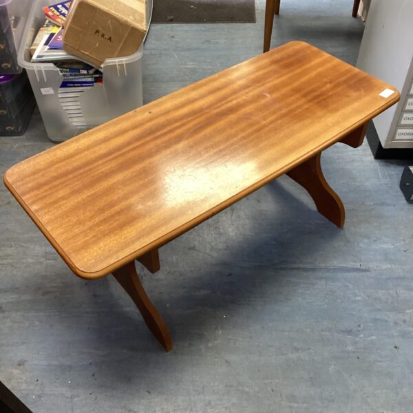 Small vintage wooden side table with curved legs.