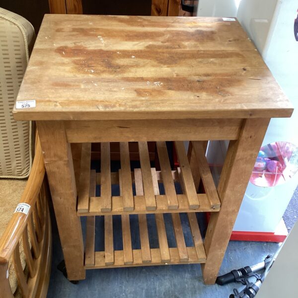 Vintage wooden butchers block with storage shelf.