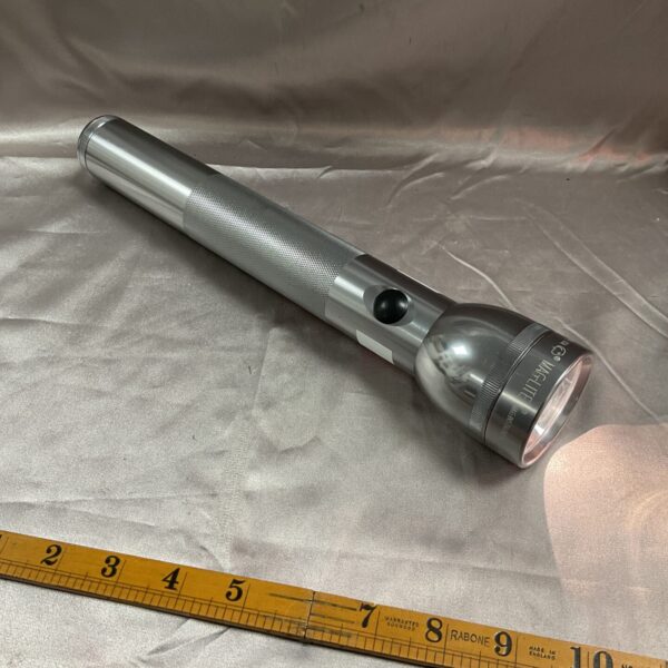 Vintage 12-inch metal Maglite flashlight in good condition.