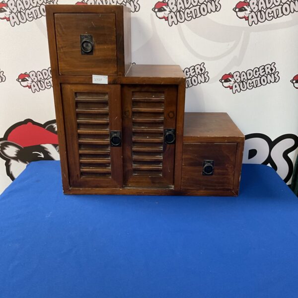 Vintage stepped storage unit with wooden drawers and shelves.