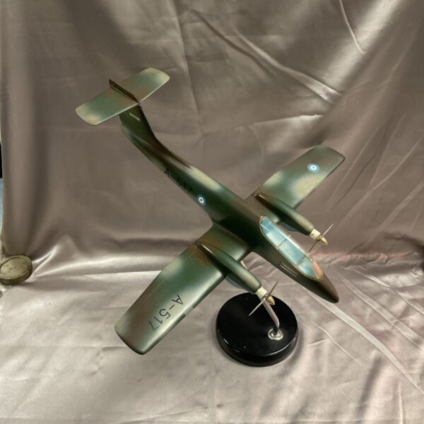 Detailed scale model of a Pucara aircraft on a stand.