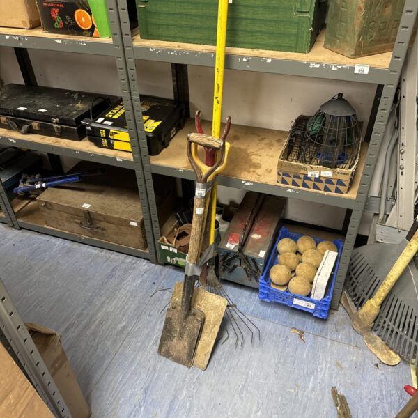 Selection of garden tools including a spade, rake, and fork.