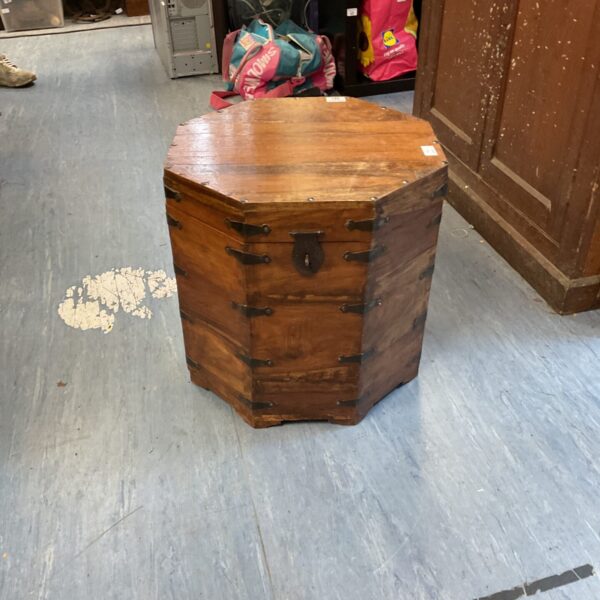 Vintage Indian oak hexagonal storage trunk with visible wood grain.
