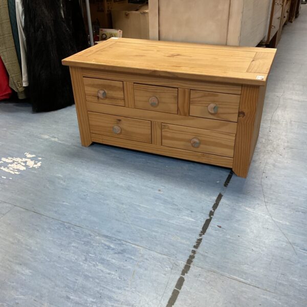 Small pine storage unit with three drawers, rustic style.