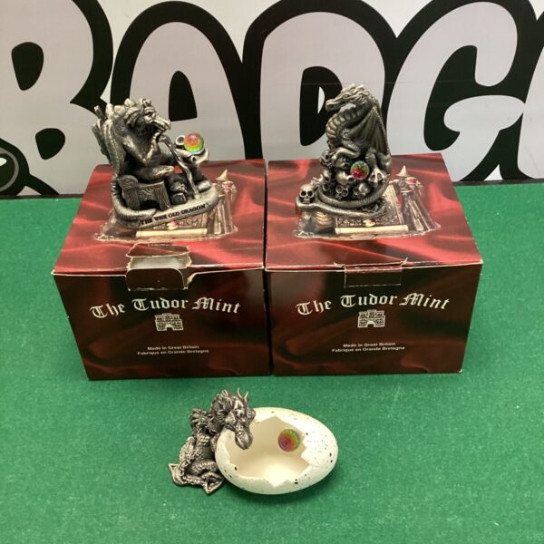 Lot of three Tudor Mint dragon ornaments, detailed fantasy sculptures.