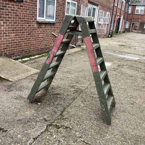 Vintage Wellwinch military step ladder in a courtyard setting.