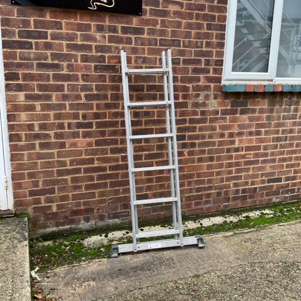 Lightweight aluminium ladder leaning against a brick wall.