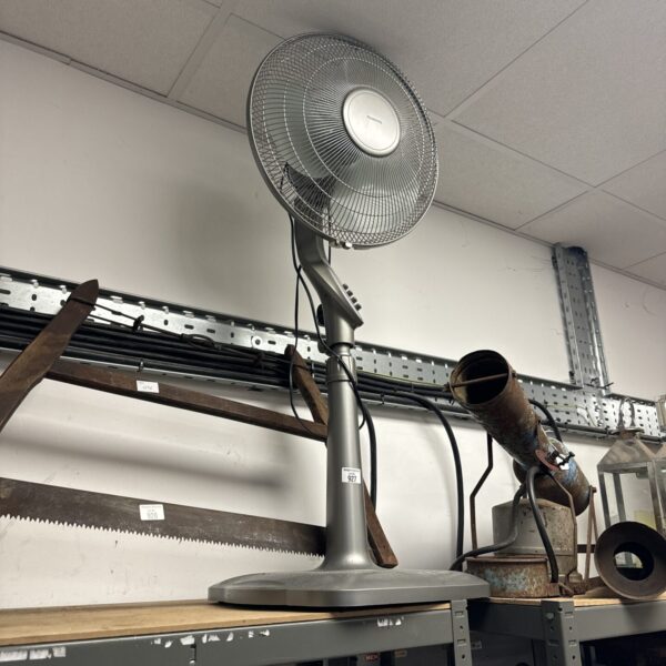 White vintage Rowenta pedestal fan for cooling and display.