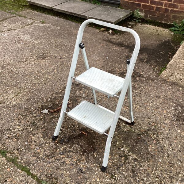 Vintage metal step ladder for kitchen use.