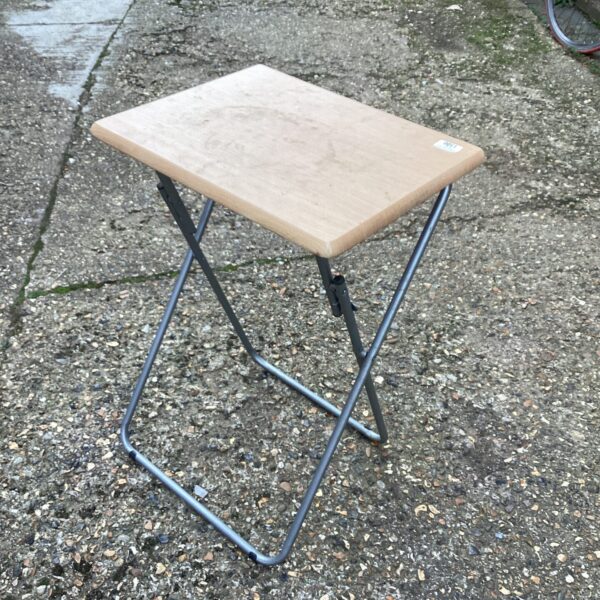 Small folding table with metal frame and laminate top.