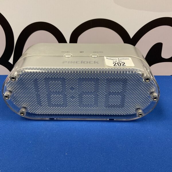 Vintage Pinclock alarm clock with textured finish and simple clock face.