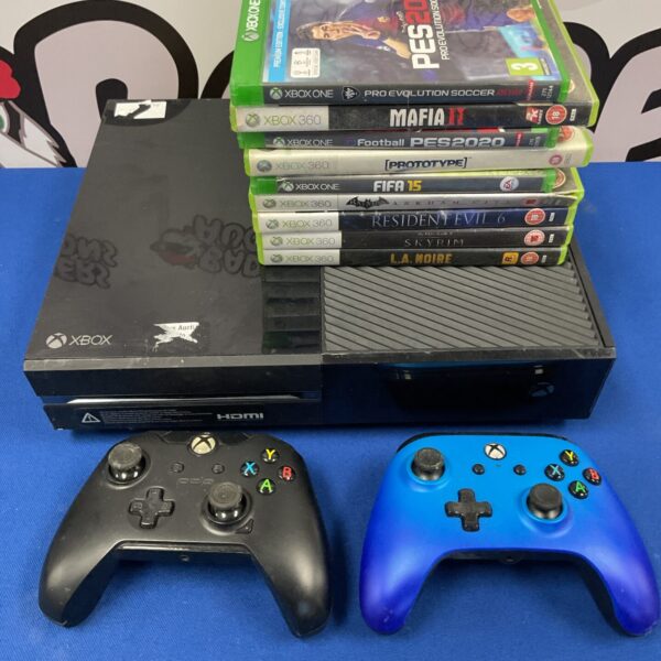 Xbox One console with controller and collection of Xbox 360 games.