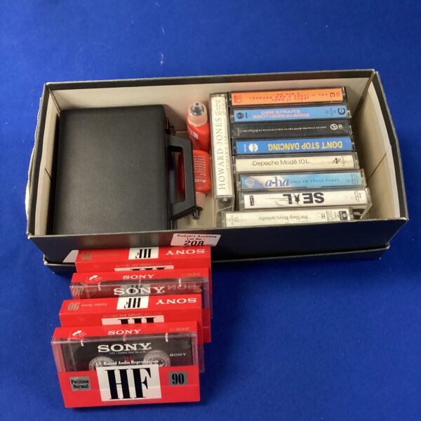 Vintage cassette tape lot with various artists and genres.