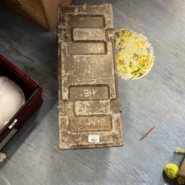 Weathered B62S military crate lid with locking mechanism.