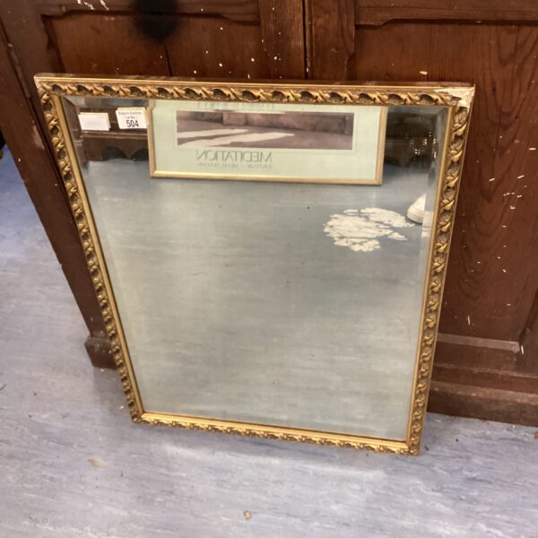 Antique gilt framed mirror with ornate gold detailing.