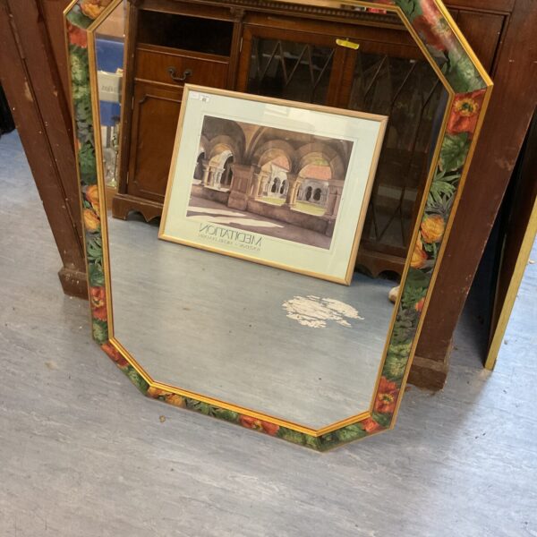 Vintage floral framed mirror with an octagonal frame.