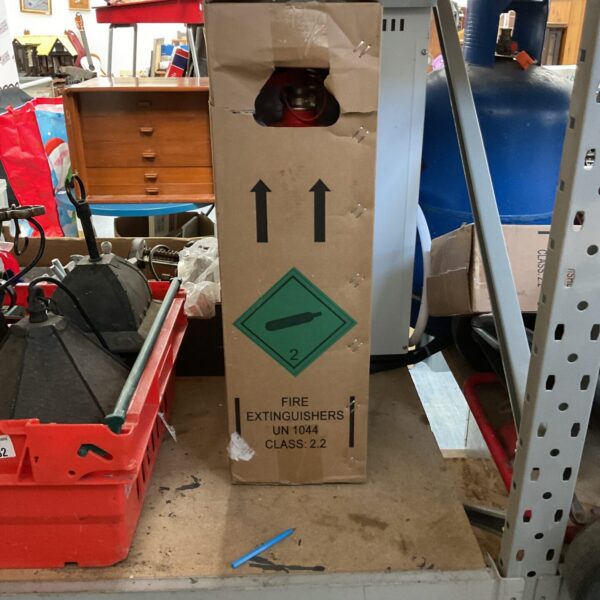 Vintage fire extinguisher box with directional arrows, collectible item.