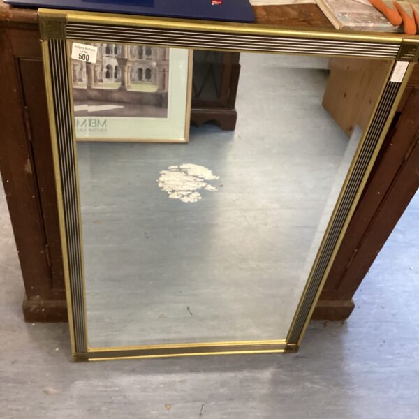 Antique gilt framed mirror with ornate detailing.