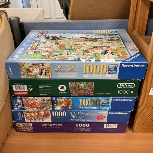 Lot of five jigsaw puzzles including Ravensburger brand.