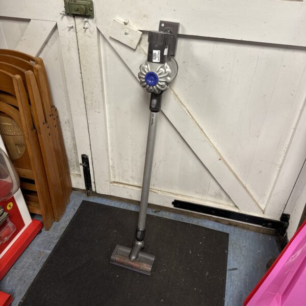 Front view of a grey Dyson V6 cordless vacuum cleaner.