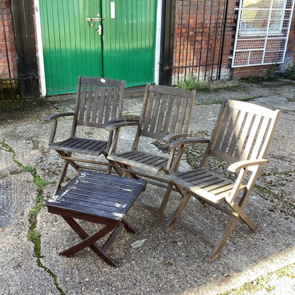 Vintage teak garden furniture set with three chairs and table.