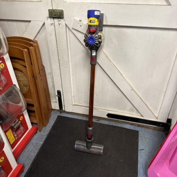 Front view of a grey and purple Dyson V8 cordless vacuum cleaner.