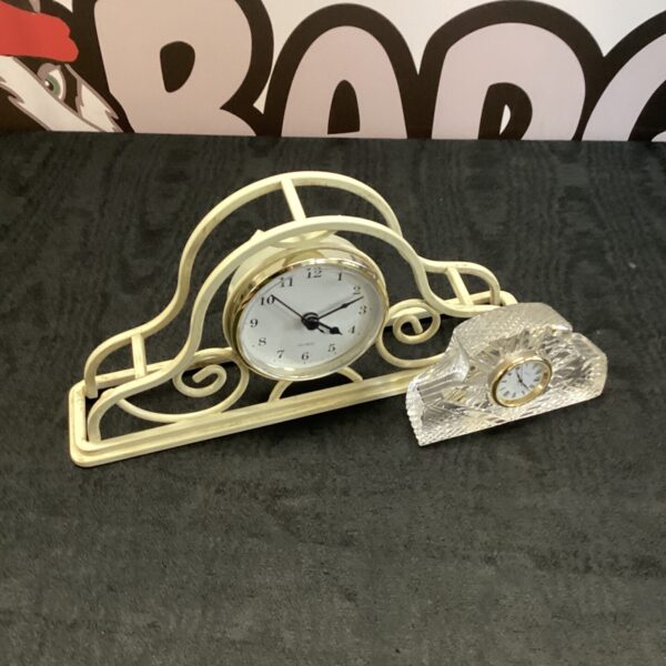 Ornate vintage mantle clock with metal frame and white face.