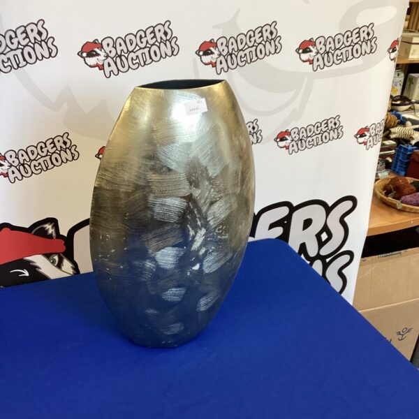 Sleek modern metal vase for home decor.